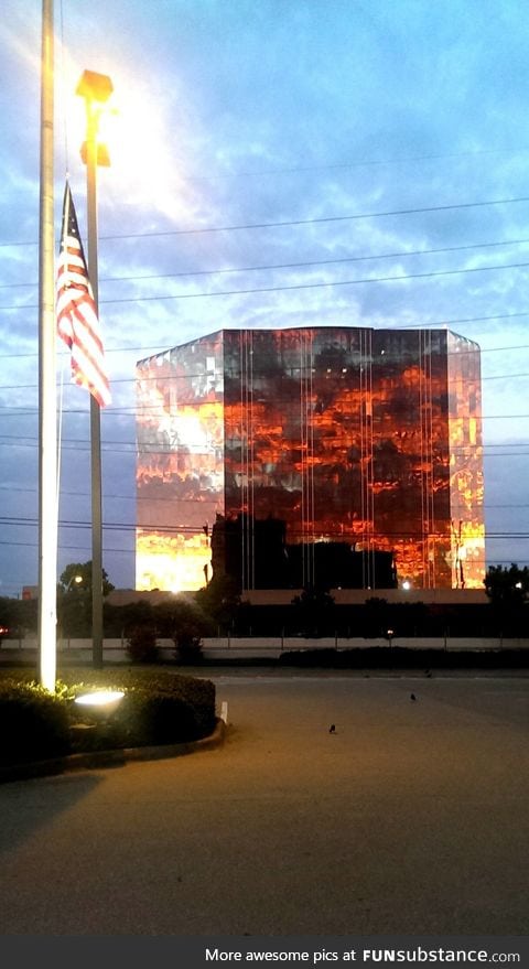 A sunset reflecting off of a building