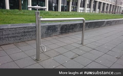 A public bike stand with a built-in pump