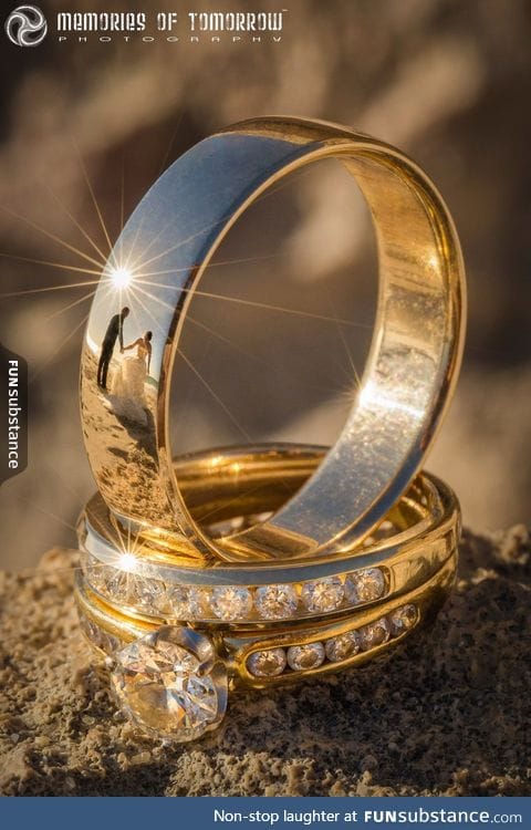 This wedding ring photo has reflections of the newlyweds