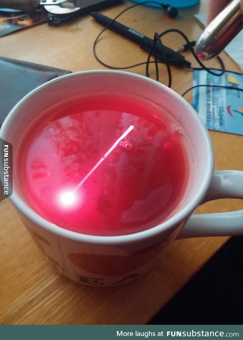 Shining a laser through tea makes the beam visible in it