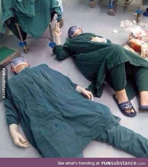 Doctors lying on the floor after a 32-hour brain operation