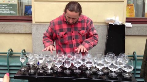 Street musician plays an impressive piece with water glasses