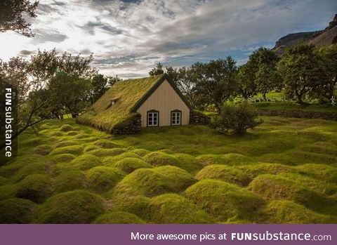 A church in Iceland is made from wood and peat, the humps are very old graves