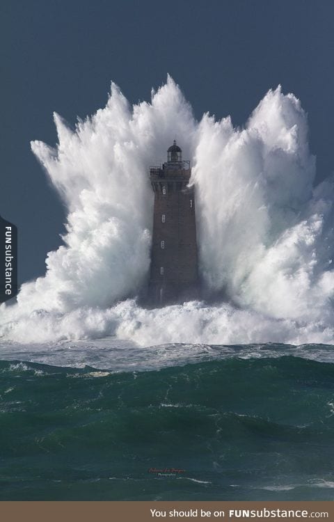 Wave bigger than the lighthouse it's hitting