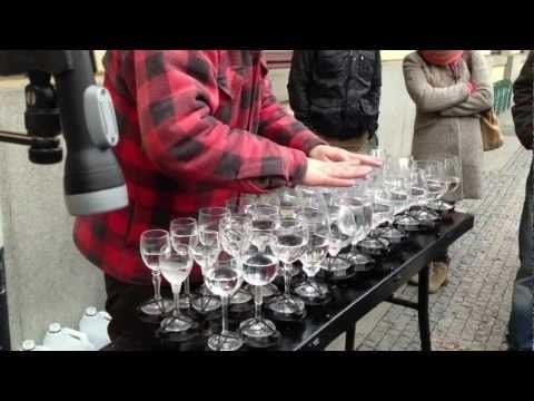 Street musician playing Hallelujah with crystal glasses