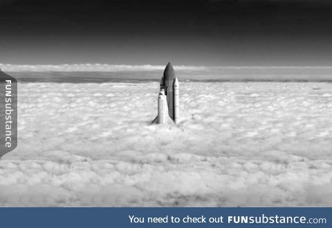 Perfectly timed shot of shuttle exiting the cloud cover