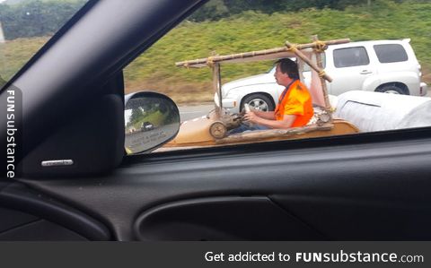 Someone is driving around the freeway in Vancouver washington in the flintstone car