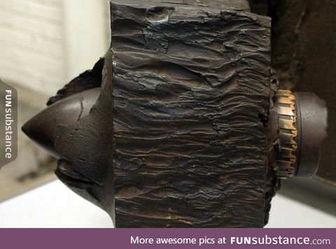 17-pdr gun "armor piercing" shell embedded in a WWII Tiger I tank armor