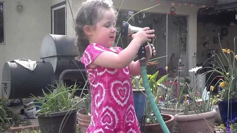 Little girl learns about water pressure with her grandmother