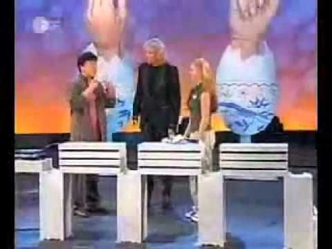Jackie Chan breaking 12 cement blocks with a punch, while holding an egg inside his fist