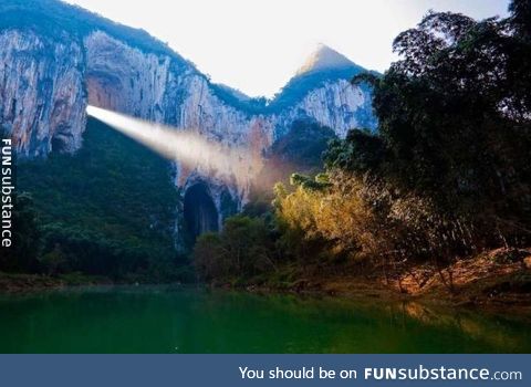 A ray of light shines through the Great Arch of Getu in China