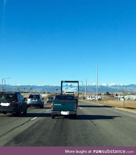 Truck lines up with Rocky Mountains