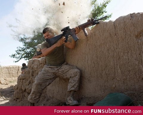 A US Marine has a close call fighting the Taliban