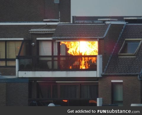 Sunset reflection makes neighbors house look like it's on fire