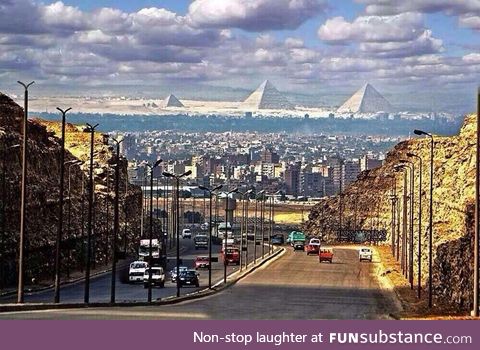 The great pyramids of Giza as seen from a street in Cairo