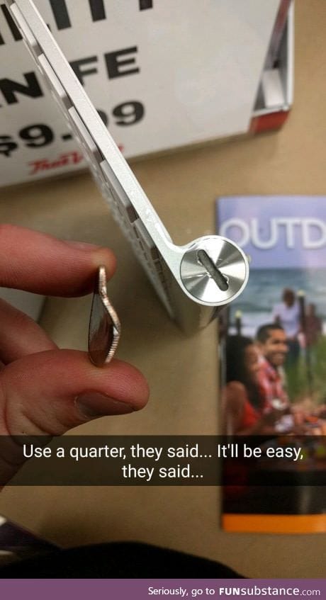 This Apple keyboard battery compartment was so hard to open that it bent this quarter