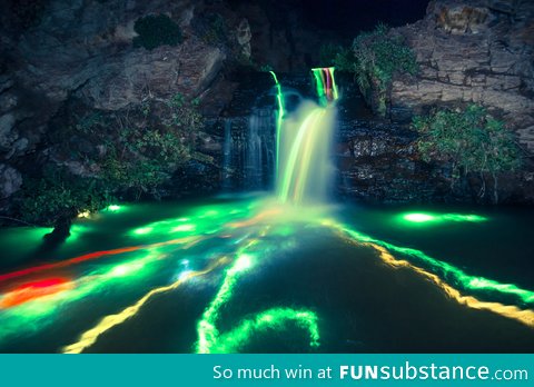 Dropped glow sticks into a waterfall