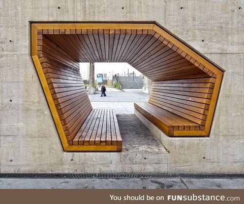 Bench through a concrete wall