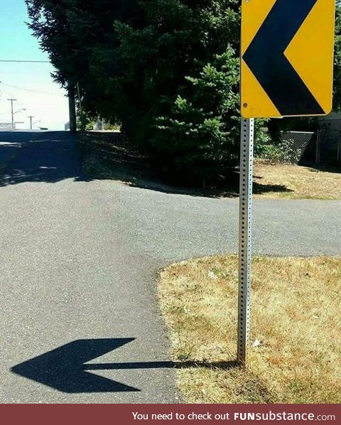 The shadow of this sign creates an arrow to the same direction