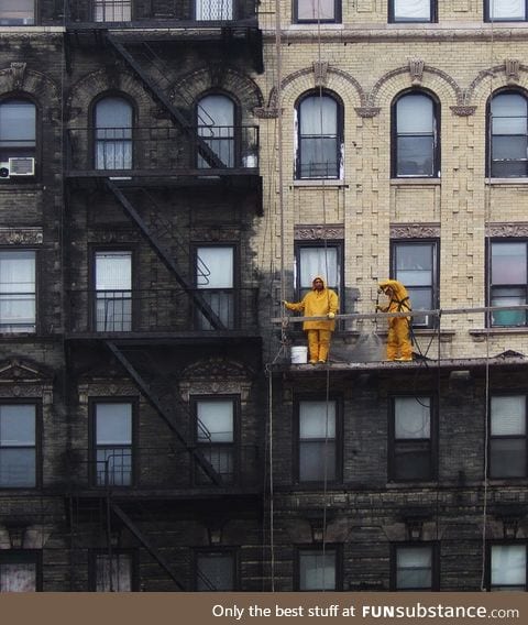 A building in New York City getting power washed and having years of grime removed