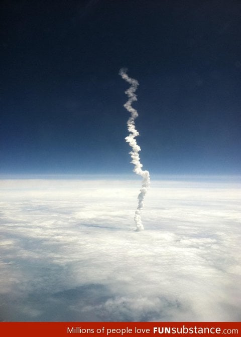 Volcano smoke above clouds