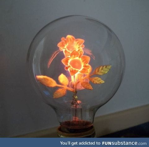 The filament of this antique light bulb is shaped like flowers