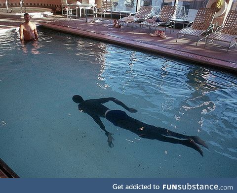 7’7” former NBA player Manute Bol in a pool