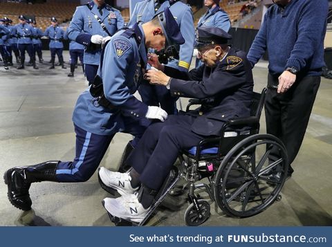 Retired Pittsfield Police Officer Enrico Giardina, 91, pins a badge on his grandson, Adam