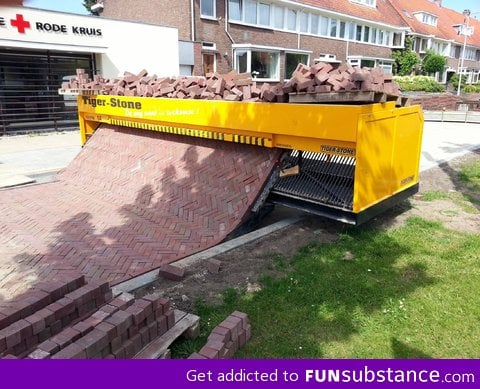 Brick laying road machine