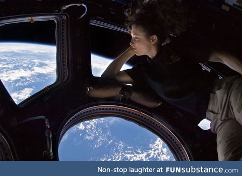 Astronaut Tracy Caldwell Dyson looking down at Earth from the ISS, 2010