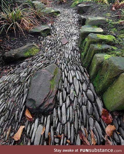 Stones placed on their sides so they give the illusion of flowing water