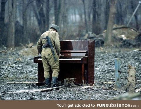 Russian soldier playing an abandoned piano in Chechnya, 1994