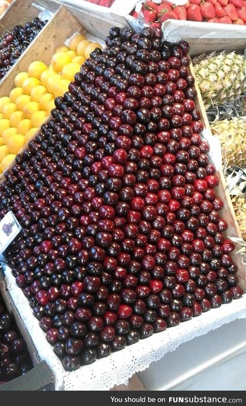 Neatly stacked cherries in market