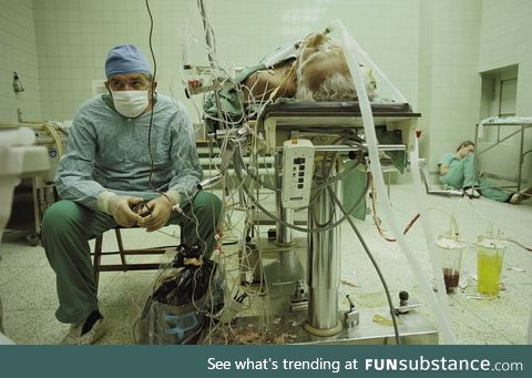Dr. Zbigniew Religa watching the vital signs of his patient after a 23 hrs long heart