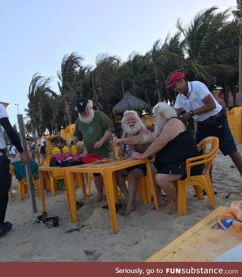 Santa Claus drinking beer on the beach after the x-mass