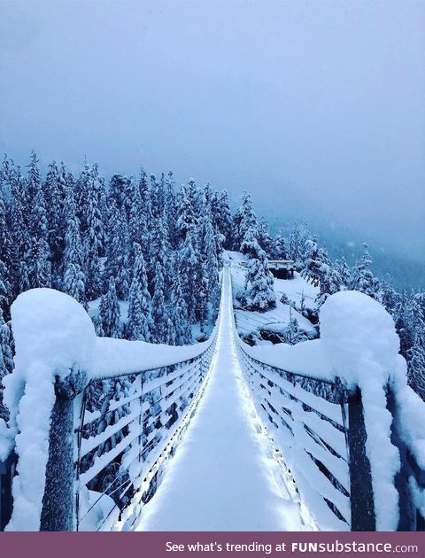 Snowy bridge leading to a gondola in Vancouver, Canada