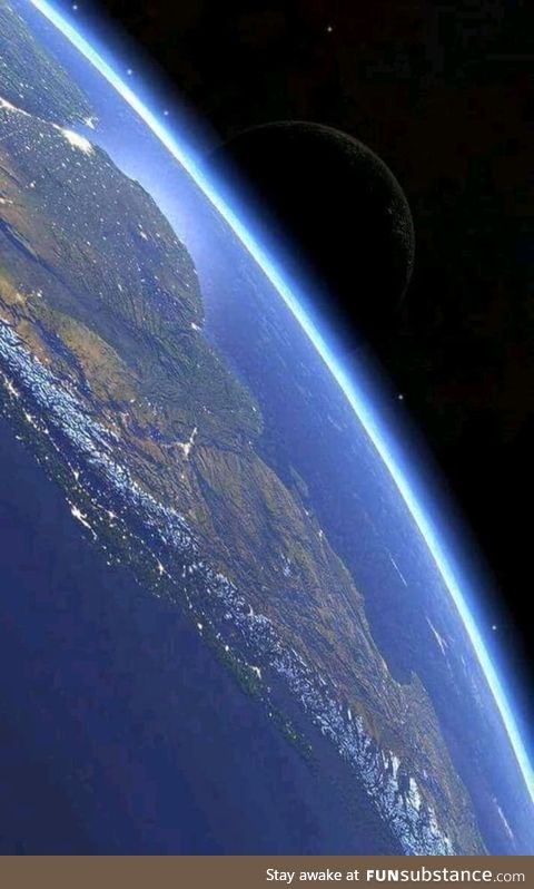 South America from the international space station featuring the moon