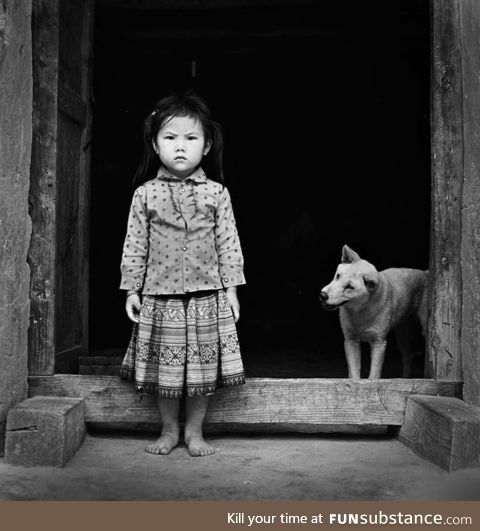 A girl and her dog. Somewhere in Vietnam, 2016
