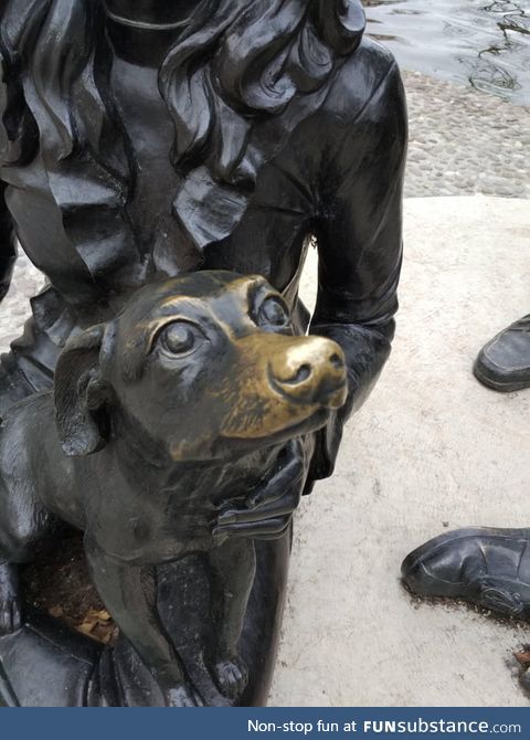 This statue dog's nose is worn away from all the people who pet it