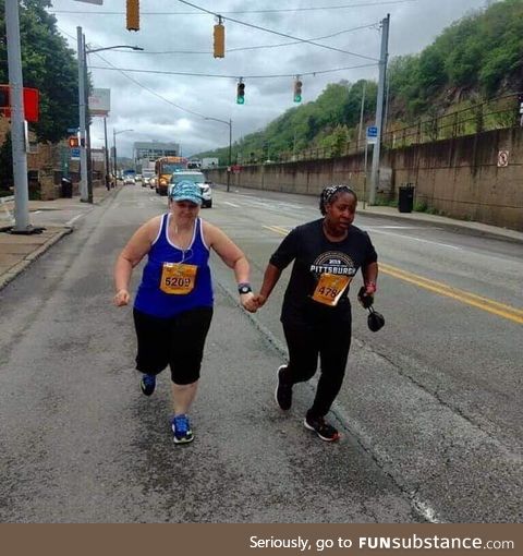 The last two runners of the Pittsburgh Marathon not letting each other quit