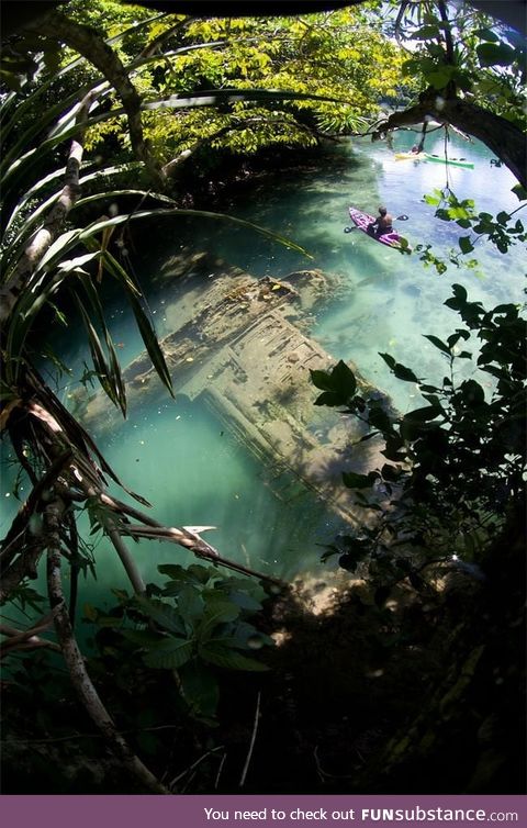A Japanese warplane Second World War lies wrecked in shallow water
