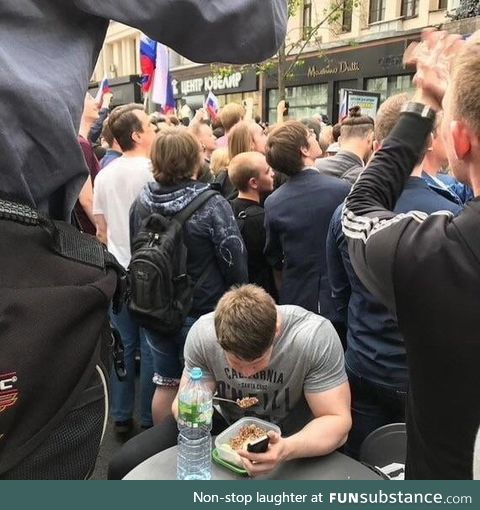 Trying to eat his breakfast in the middle of a protest