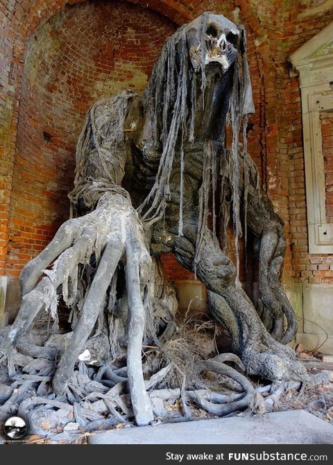 Demon statue at an abandoned mausoleum in Poland