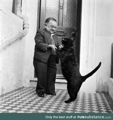 World's smallest man in 1956, Henry Berhens, dancing with his cat