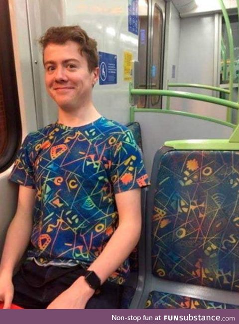 Dude wears a t-shirt identical with the bus seats