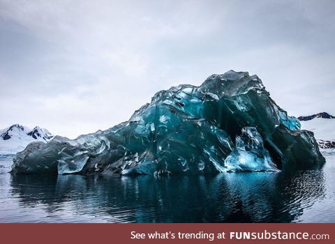 An iceberg flipped over, and its underside is breathtaking