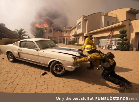 Firefighters saving a classic car from the California wildfires