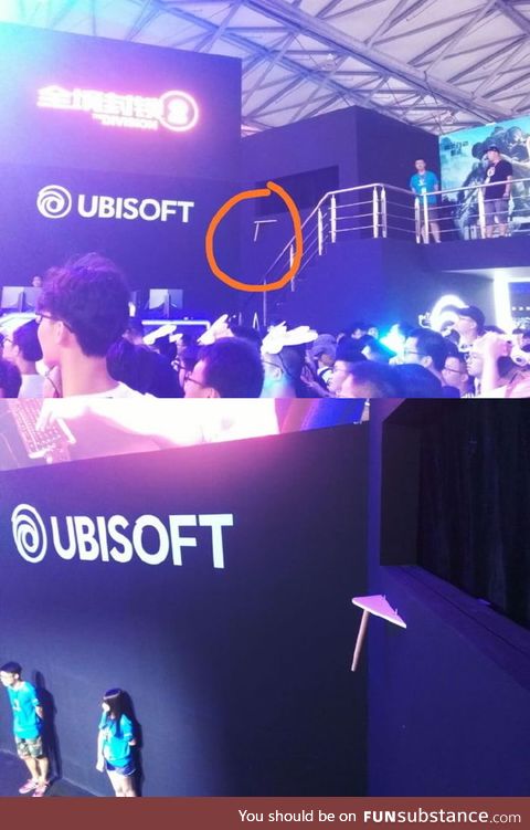 LMAO Ubisoft makes fun of itself by adding a clipped table on a wall of its stage on