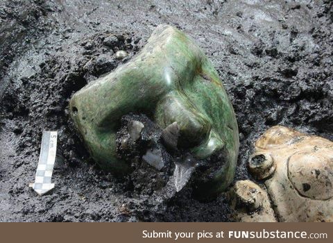 A 2000 years old green serpentine stone mask found at the base if an ancient pyramid in