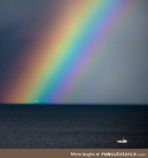 I saw a boat caught in a rainbow